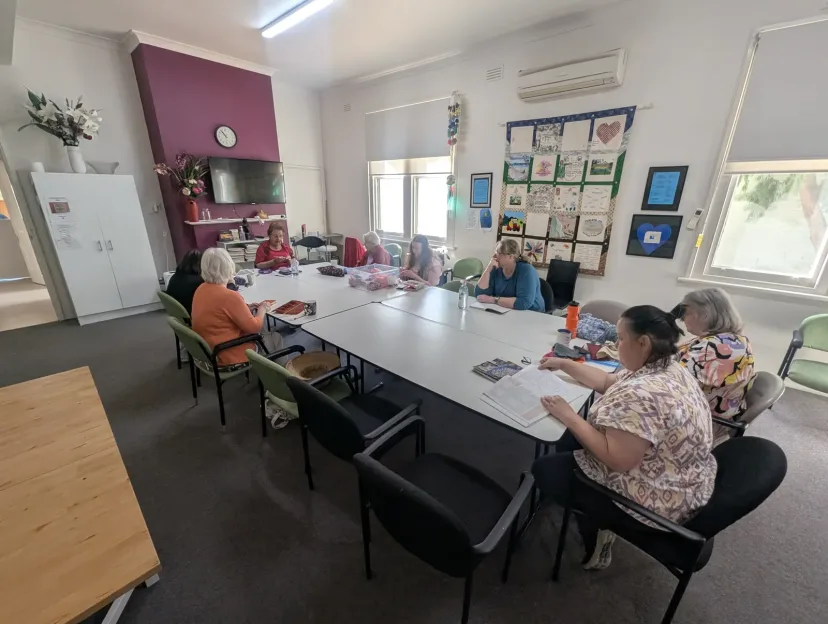 A group taking part in an activity around a table at the Neighbourhood Centre